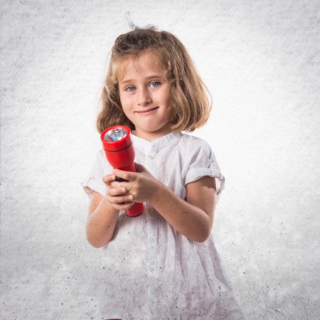Girl holding a flashlightの写真素材