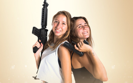 Friends holding a SMG and a gunの写真素材