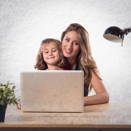 Mother and daughter working in officeの写真素材