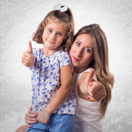 Mother and daughter with thumb upの写真素材