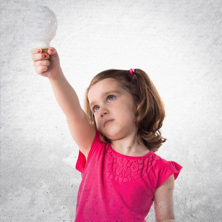Girl holding a bulbの写真素材