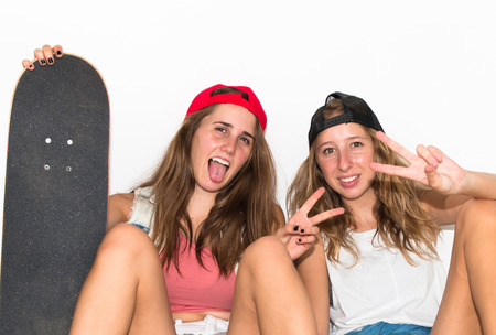 Friends with their skateboards doing victory gestureの写真素材