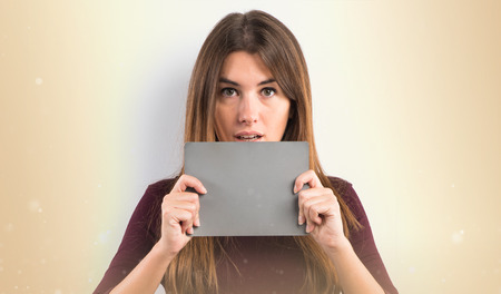 Pretty woman holding an grey placardの写真素材