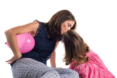Mother and daughter playing with balloonsの写真素材