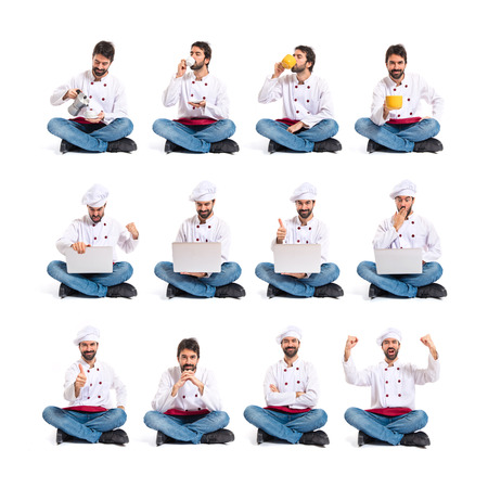 Chef with laptop over isolated white backgroundの写真素材