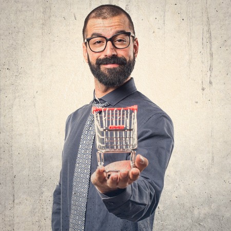 Man holding a supermarket cartの写真素材