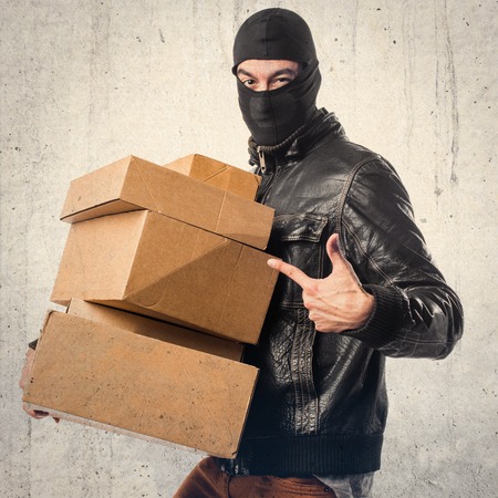 Robber holding boxesの写真素材