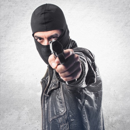 Robber shooting with a pistol