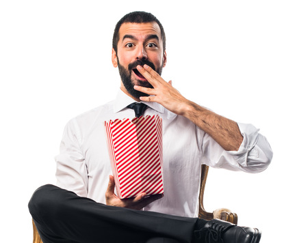 Businessman eating popcornsの写真素材