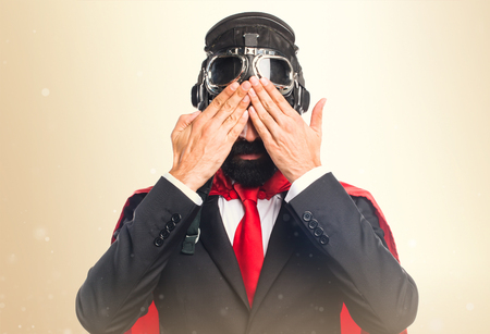 Super hero businessman covering his eyesの写真素材