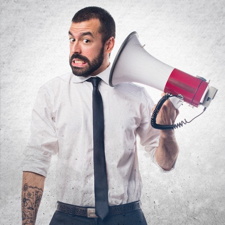 Businessman shouting by megaphoneの写真素材