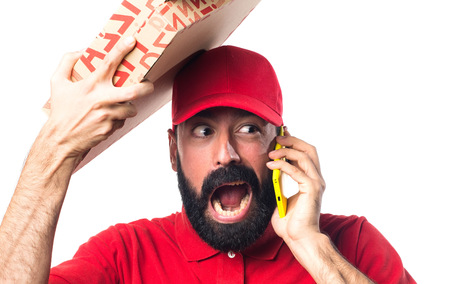 Pizza delivery man talking to mobileの写真素材