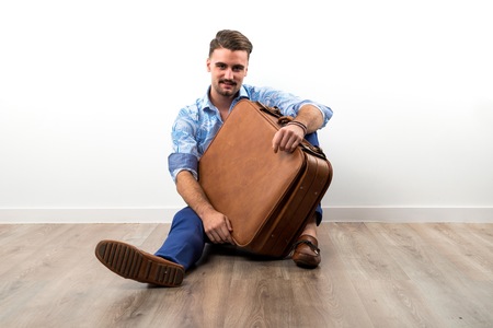 Model man in studio with suitcaseの写真素材