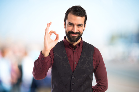 Man wearing waistcoat making Ok signの写真素材