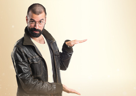 Man wearing a leather jacket holding somethingの写真素材