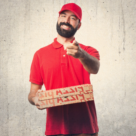 Pizza delivery man pointing to the frontの写真素材