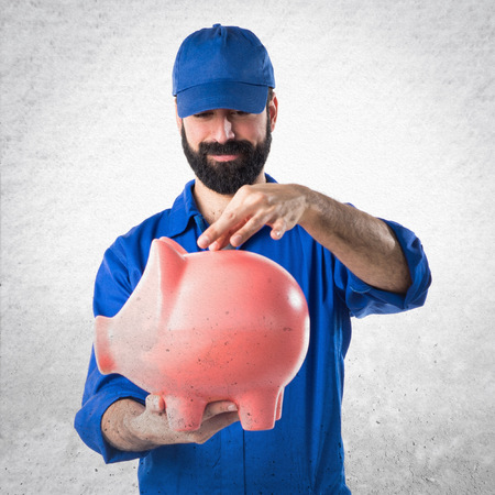 Plumber holding a piggybankの写真素材