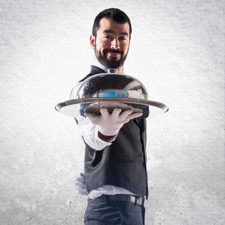 Luxury waiter holding a trayの写真素材