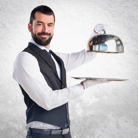 Luxury waiter holding a trayの写真素材