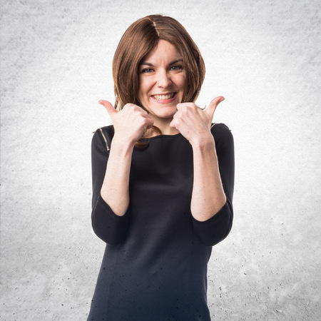 Brunette woman with thumb upの写真素材