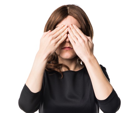 Brunette woman covering her eyesの写真素材