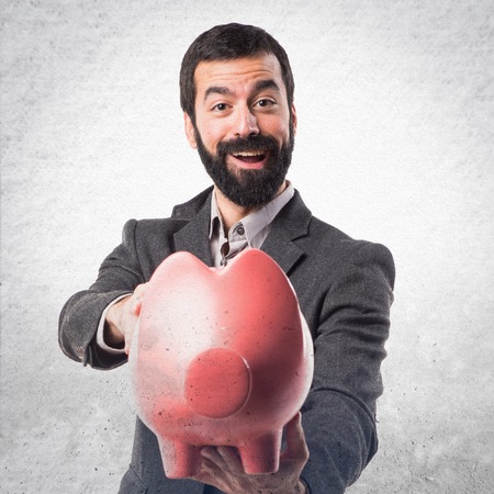 Man holding a piggybankの写真素材