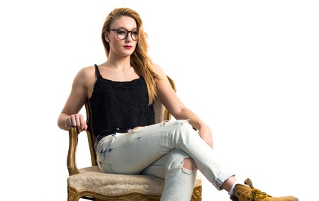 Blonde woman on vintage armchairの写真素材