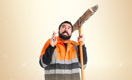 Garbage man with his fingers crossingの写真素材