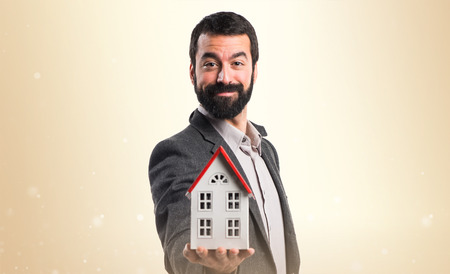 Man holding a little houseの写真素材