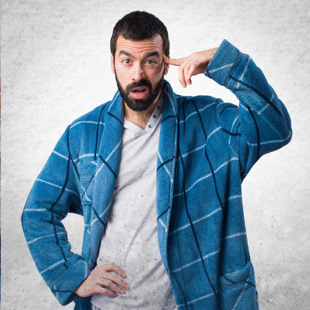 Man in dressing gown making crazy gestureの写真素材