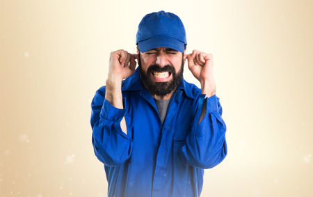 Plumber covering his earsの写真素材