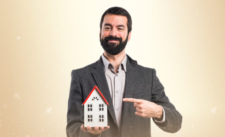 Man holding a little houseの写真素材