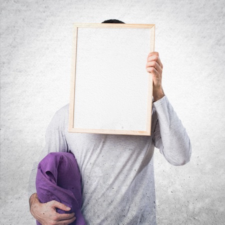 Man in pajamas holding an empty placardの写真素材
