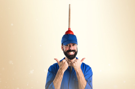 Plumber holding a plungerの写真素材