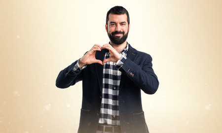 Man making a heart with his handsの写真素材