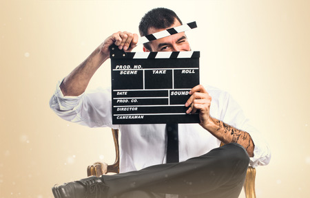 Businessman holding a clapperboardの写真素材