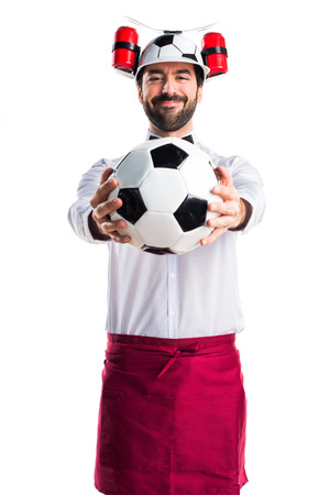 Crazy waiter holding a soccer ballの写真素材