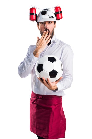 Crazy waiter holding a soccer ballの写真素材