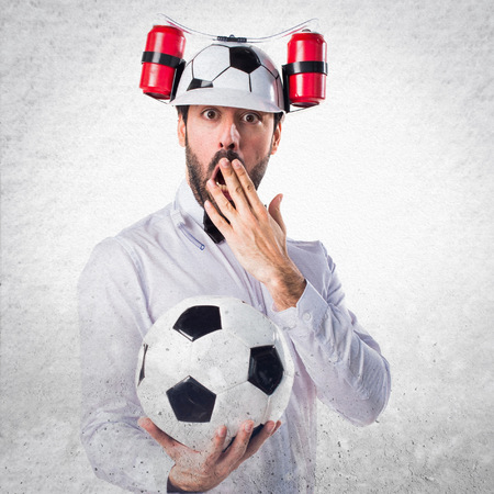 Crazy waiter holding a soccer ballの写真素材