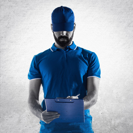 Delivery man with folderの写真素材