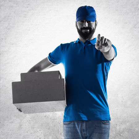 Delivery man pointing to the frontの写真素材