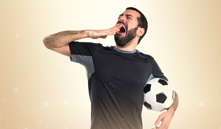 Football player yawningの写真素材