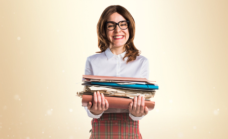 Student girl holding several college notesの写真素材