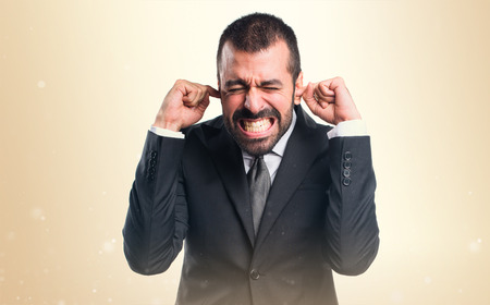 Businessman covering his earsの写真素材