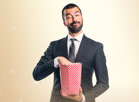 Businessman eating popcornsの写真素材