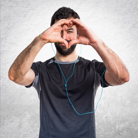 Sportman making a heart with his handsの写真素材