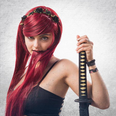 Young redhead girl with katanaの写真素材