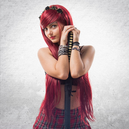 Young redhead girl with katanaの写真素材