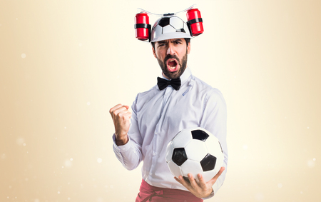 Crazy waiter holding a soccer ballの写真素材