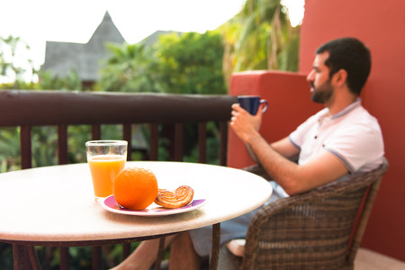 Man having breakfast on hotel terraceの写真素材
